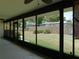 Enclosed lanai showcasing views of the spacious backyard with lush green grass and partial fencing at 2865 Se 37Th St, Ocala, FL 34471