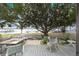 Backyard area features a patio area, mature trees, lawn, and stunning views of the water at 31 Se Chinica Dr, Summerfield, FL 34491