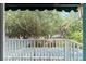 Balcony with a view of lush greenery and partial view of the water at 31 Se Chinica Dr, Summerfield, FL 34491