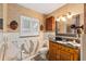 Charming bathroom features custom vanity and mosaic tiled walls with decorative accents at 31 Se Chinica Dr, Summerfield, FL 34491