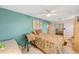 Cozy bedroom with a ceiling fan, floral bedding, and a sliding door closet at 31 Se Chinica Dr, Summerfield, FL 34491