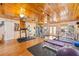 Large home gym features diverse equipment, wood ceiling, and ample natural light at 31 Se Chinica Dr, Summerfield, FL 34491