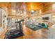 Well-equipped exercise room with multiple machines, wood ceiling, and comfortable flooring at 31 Se Chinica Dr, Summerfield, FL 34491