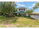 Charming two-story home with balcony, manicured lawn and garden at 31 Se Chinica Dr, Summerfield, FL 34491
