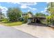 Charming two-story home with a covered parking area and mature landscaping at 31 Se Chinica Dr, Summerfield, FL 34491