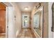 Inviting foyer with wood paneled walls, terracotta tile, and glass door leading to the outside at 31 Se Chinica Dr, Summerfield, FL 34491