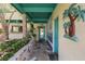 Charming front entrance with custom tile walkway, teal accents, and lush landscaping at 31 Se Chinica Dr, Summerfield, FL 34491