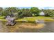 Lakeside retreat featuring lush greenery, private beach, and scenic water views at 31 Se Chinica Dr, Summerfield, FL 34491