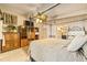 Bedroom features a four-poster bed, wood paneled walls, and an attached bathroom at 31 Se Chinica Dr, Summerfield, FL 34491
