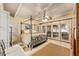 Bedroom with a four poster bed, tile floors, light colored walls and lots of natural light at 31 Se Chinica Dr, Summerfield, FL 34491