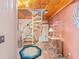Entryway with a spiral staircase, terracotta tile flooring, and a unique shelving unit at 31 Se Chinica Dr, Summerfield, FL 34491