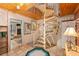 Hallway featuring a spiral staircase with white railings and terracotta tile floors at 31 Se Chinica Dr, Summerfield, FL 34491