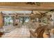 Bright sun room with tile flooring, wicker furniture, and expansive water views at 31 Se Chinica Dr, Summerfield, FL 34491