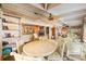 Open sunroom with white paneled ceiling and wicker seating, and open view to other interior spaces at 31 Se Chinica Dr, Summerfield, FL 34491