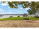 Beautiful waterfront property with lush green lawn and sandy shoreline at 31 Se Chinica Dr, Summerfield, FL 34491