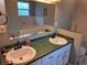 Spacious bathroom showcasing double sinks, a large mirror, and a luxurious tub at 33 Pecan Pass Trl, Ocala, FL 34472