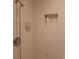 Tiled shower stall featuring handheld shower head, soap dish, and built-in niche for toiletries at 33 Pecan Pass Trl, Ocala, FL 34472