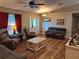 Bright and airy living room with vaulted ceiling, wood floors, large windows, and comfortable furnishings at 33 Pecan Pass Trl, Ocala, FL 34472