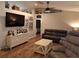 Cozy living area with vaulted ceilings, wood floors, neutral paint, and comfortable leather furnishings at 33 Pecan Pass Trl, Ocala, FL 34472