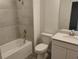 A full bathroom with neutral tile and a bathtub at 3571 Se 37Th Ct, Ocala, FL 34480
