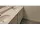 Bathroom featuring double sinks, quartz countertops, modern tile flooring, and large mirror at 3571 Se 37Th Ct, Ocala, FL 34480