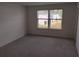 Bedroom featuring plush carpeting, neutral paint, and a natural light filled window at 3571 Se 37Th Ct, Ocala, FL 34480
