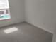 Bedroom featuring plush carpeting, neutral paint, and a natural light filled window at 3571 Se 37Th Ct, Ocala, FL 34480