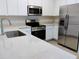 Bright kitchen featuring stainless steel appliances, white cabinets, and quartz countertops at 3571 Se 37Th Ct, Ocala, FL 34480