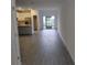 Open-concept living room with wood-look tile floors, and sliding glass doors to outdoor at 3571 Se 37Th Ct, Ocala, FL 34480