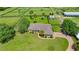 Aerial view of the house, which features a well-manicured lawn and a long, curving driveway at 5415 Nw 100Th St, Ocala, FL 34482