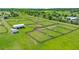 Aerial view showcasing multiple paddocks, stables, and green pastures on this picturesque horse property at 5415 Nw 100Th St, Ocala, FL 34482