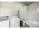 Bathroom with a shower, washing machine, and dryer, perfect for post-riding convenience at 5415 Nw 100Th St, Ocala, FL 34482