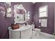 Stylish bathroom with a vanity, ornate mirror, a window for natural light, and a mosaic tiled floor at 5415 Nw 100Th St, Ocala, FL 34482