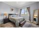 Bright bedroom with a comfortable queen bed, nightstands, and a large window with a view at 5415 Nw 100Th St, Ocala, FL 34482