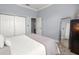 Comfortable bedroom with a queen bed, double door closet, and a standing mirror at 5415 Nw 100Th St, Ocala, FL 34482
