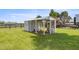 Enclosed chicken coop on a lush green lawn with a classic white frame at 5415 Nw 100Th St, Ocala, FL 34482