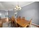 Comfortable dining room featuring a wooden table and modern chandelier at 5415 Nw 100Th St, Ocala, FL 34482