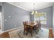 Bright dining room featuring a wooden table, chandelier, and large window at 5415 Nw 100Th St, Ocala, FL 34482