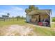 Equipment shed featuring hay bales and a lawnmower, offering ample storage and convenience at 5415 Nw 100Th St, Ocala, FL 34482