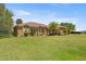 Attractive single-story home featuring a stone facade, manicured lawn, and mature landscaping at 5415 Nw 100Th St, Ocala, FL 34482