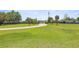 Long driveway leads to a grand entrance, surrounded by green lawns and mature trees at 5415 Nw 100Th St, Ocala, FL 34482