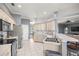 Bright kitchen with stainless steel appliances and breakfast bar seating at 5415 Nw 100Th St, Ocala, FL 34482