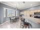 Charming kitchen featuring a breakfast bar, stainless steel appliances, and window seating at 5415 Nw 100Th St, Ocala, FL 34482