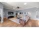 Spacious living room with a large sectional sofa and wood flooring at 5415 Nw 100Th St, Ocala, FL 34482