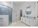 Main bathroom featuring a glass-enclosed shower and white cabinetry at 5415 Nw 100Th St, Ocala, FL 34482