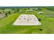 Open riding arena with diverse equestrian obstacles, nestled in a verdant landscape with well-maintained perimeter fencing at 5415 Nw 100Th St, Ocala, FL 34482