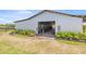 Exterior view of a stable featuring an open entrance and individual stalls at 5415 Nw 100Th St, Ocala, FL 34482