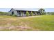 Outdoor horse stable with greenery along the entrance and side of the building at 5415 Nw 100Th St, Ocala, FL 34482