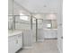Modern bathroom featuring a glass-enclosed shower, dual vanities, and sleek fixtures at 5714 Sw 75Th Ave, Ocala, FL 34474