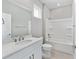 Bathroom featuring white cabinets, quartz countertop, and a shower and tub combination at 5714 Sw 75Th Ave, Ocala, FL 34474